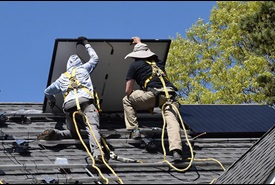 A photograph of solar panels being installed on a Falmouth home through the Energy Saver Home Loan Program