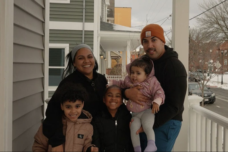 A photo of Alexis, Delyann and their family at their new home.